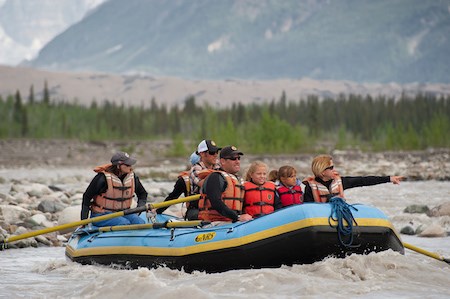 A family rafts down a river.
