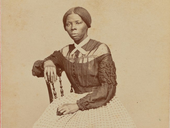 Harriet Tubman seated on a chair