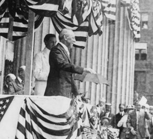Woodrow Wilson speaks from a box draped with bunting