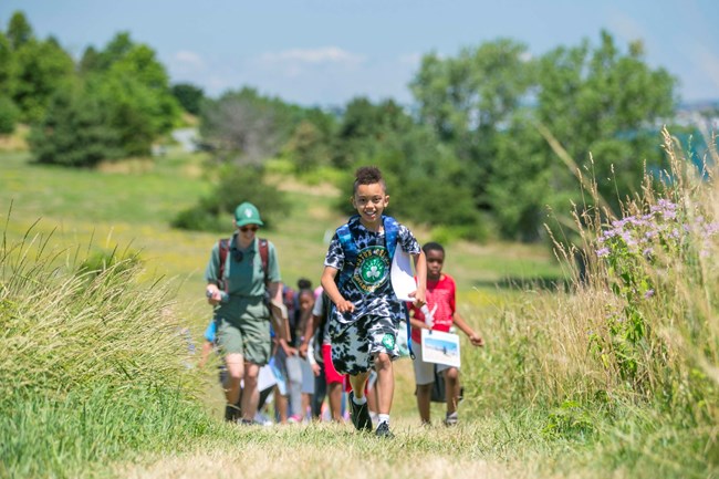 Kids walking on a trail.