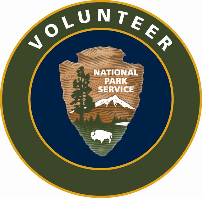 A round, blue, green, and yellow digital graphic with the NPS arrowhead in the center and white text at the top reading volunteer.