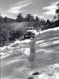 1930s truck on snow-covered mountain road