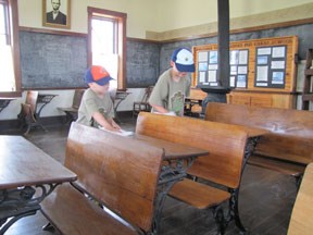 Scouts cleaning the school desks
