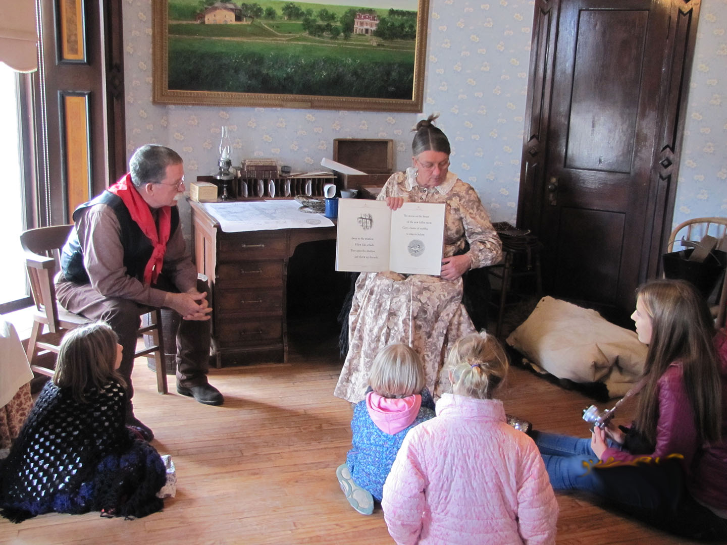 Santa's helpers read Twas The Night Before Christmas to the children