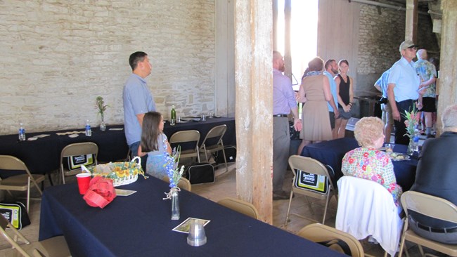 People eating dinner in the historic barn as a special event