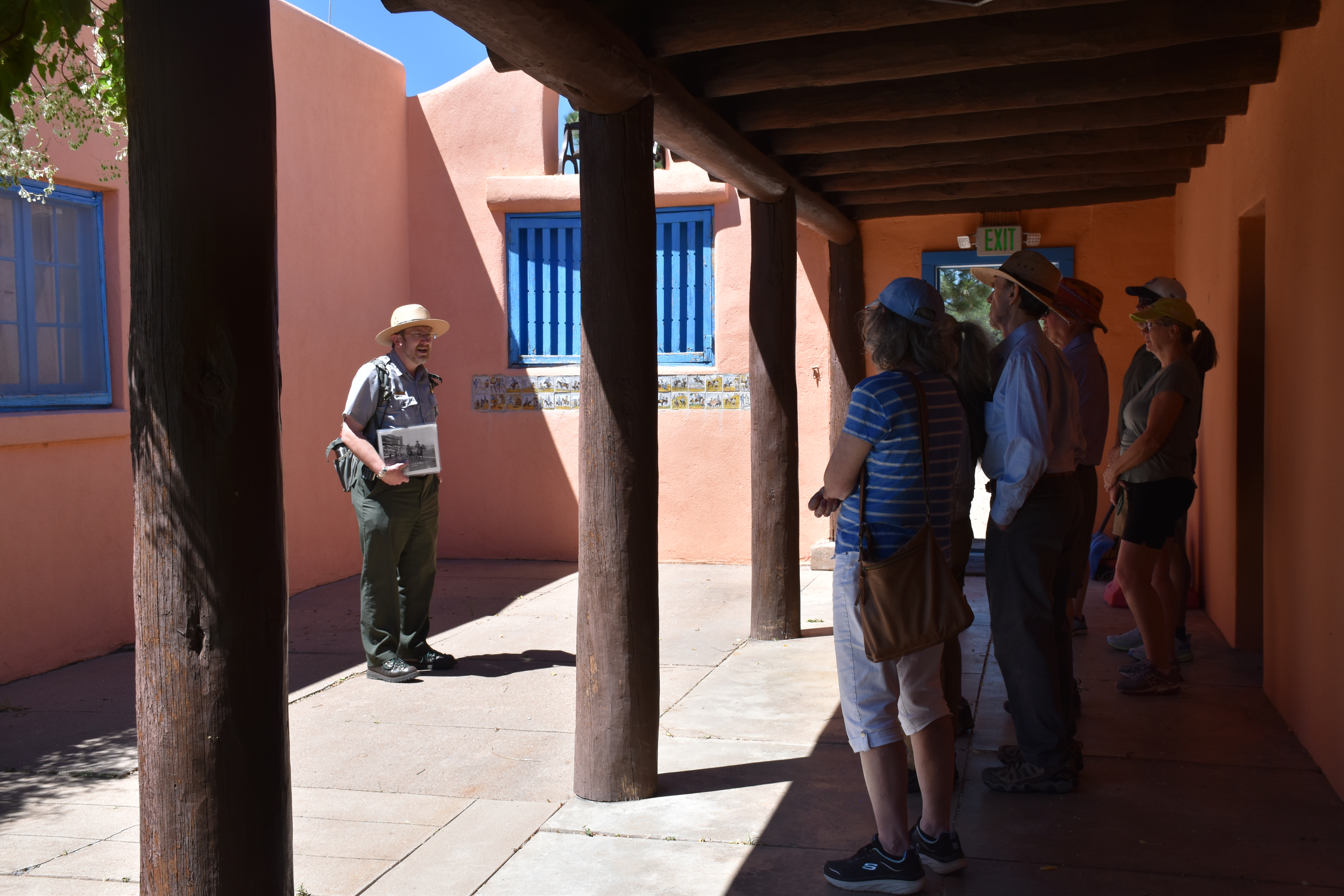 Ranger leading group in historic courtyard.