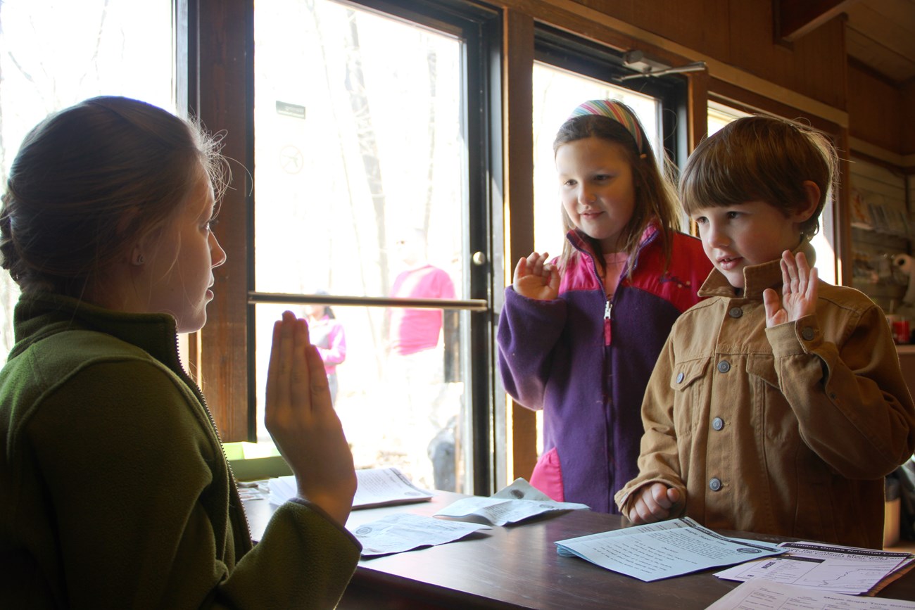 Children take the Junior Ranger pledge as they are sworn in.