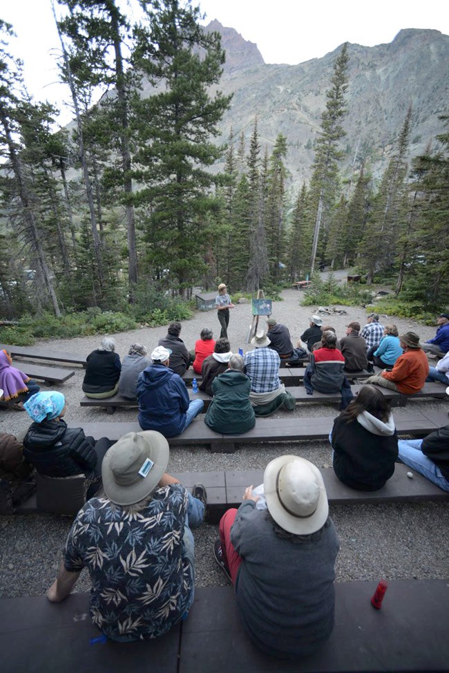Ranger speaks to group at campground amphitheater