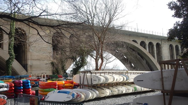 Stacks of Canoes and kayaks outside the boathouse