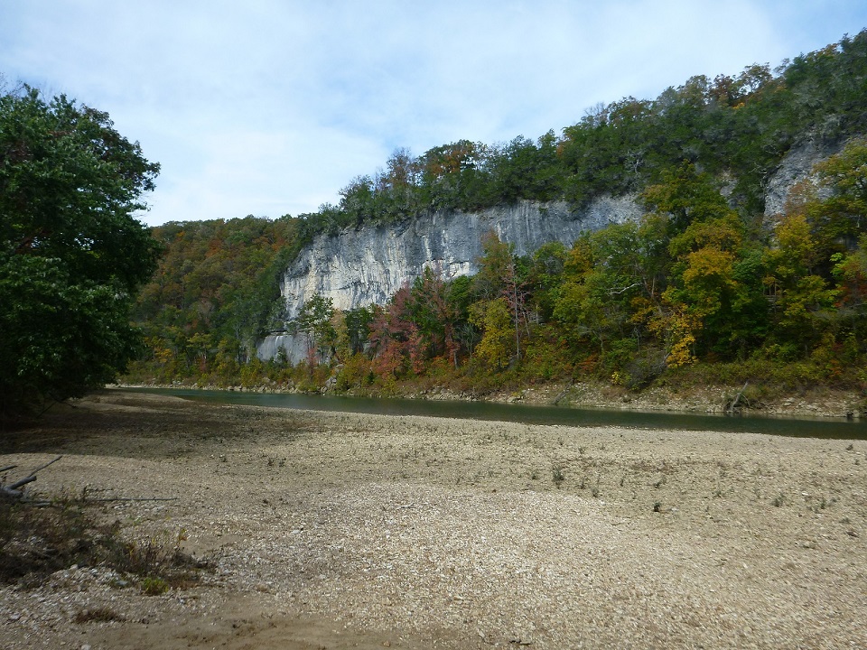 river with bluff in background and gravel bar in foreground