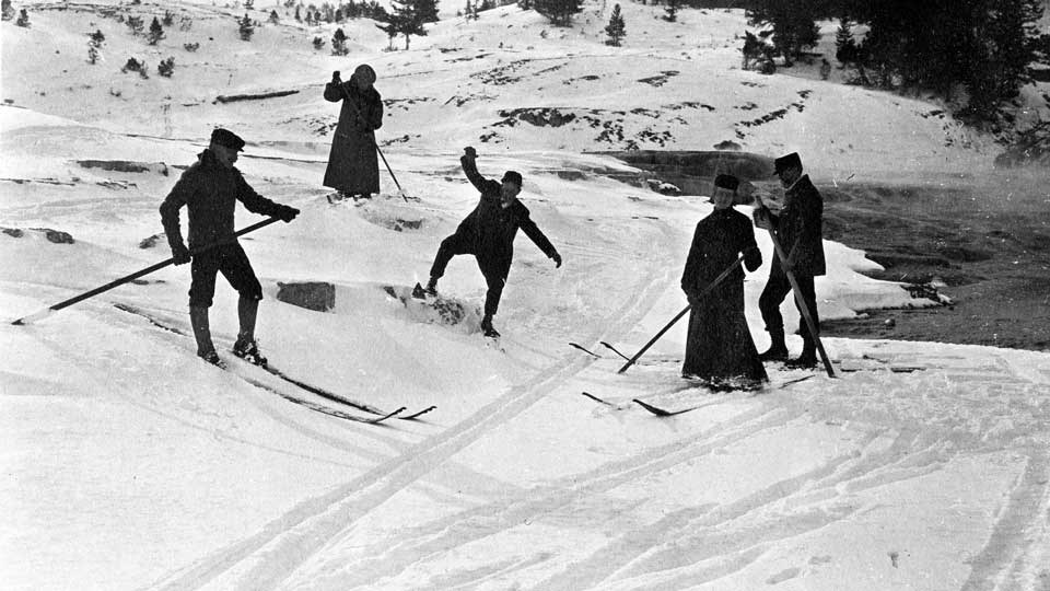 People trying to ski circa 1910