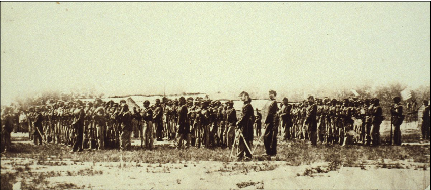 A black and white photograph showing eight lines of African American troops in a marching formation facing the left side of the photo.