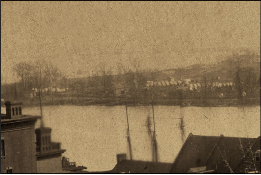 A black and white photograph taken from a high elevation in Georgetown looking across the Potomac River towards TRIS.