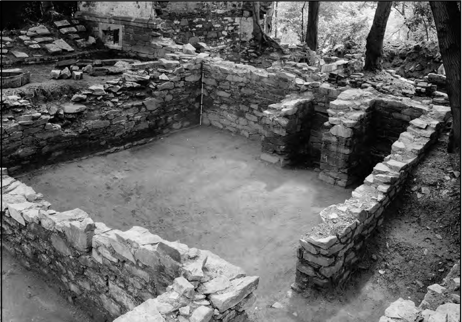 A black and white photograph showing the stone building foundation of the Mason House.