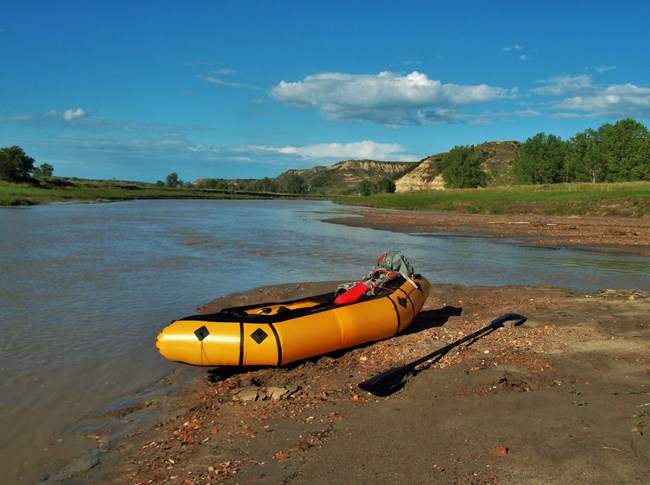 A recreational boat on the side of the Little Missouri River.