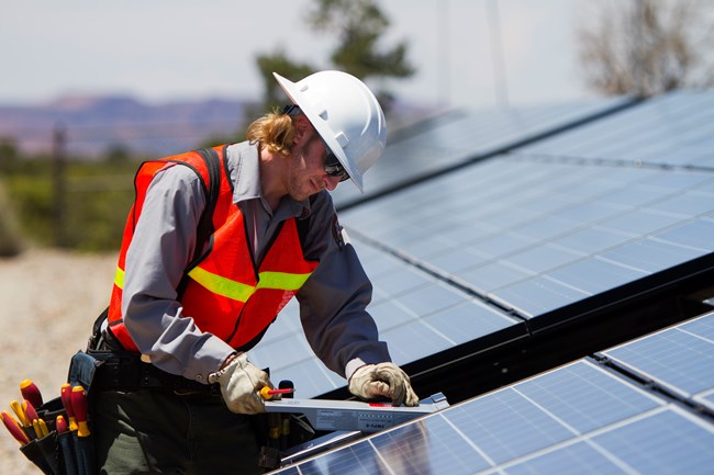 Staff working on the solar panel array at Natural Bridges National Monument