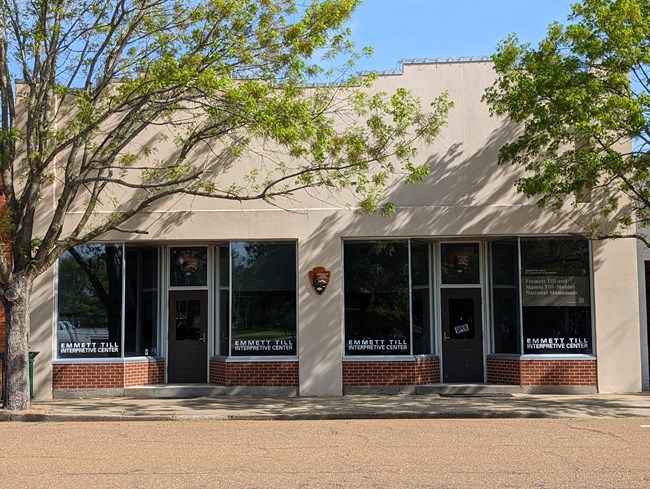 exterior of a storefront with an open sign hanging in the window