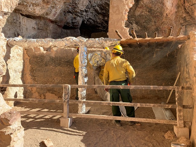 Cliff Dwelling being wrapped to prepare for wildfire
