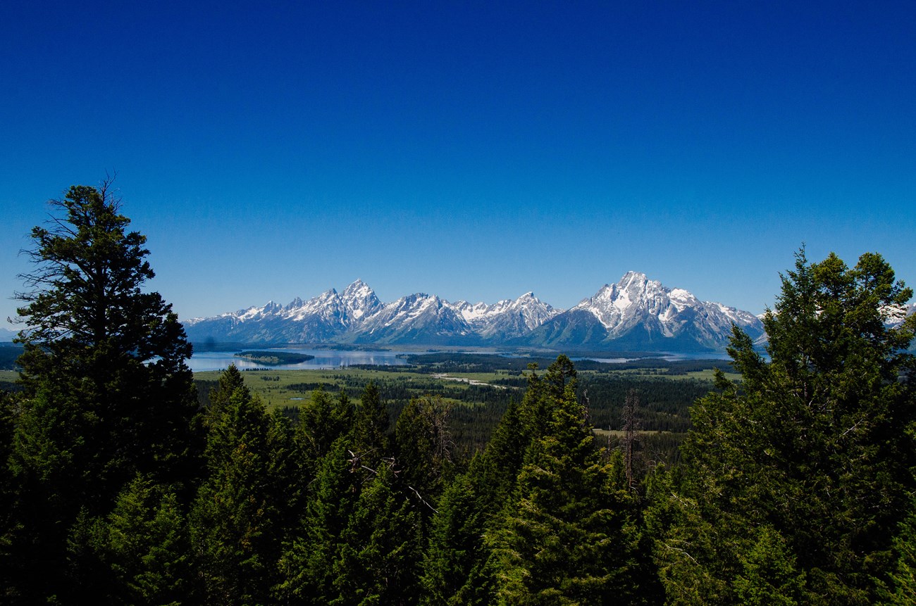 A mountain range and a lake as viewed from a high vantage point.