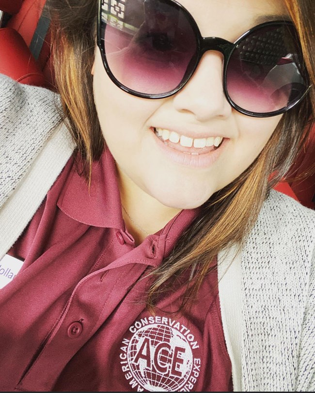 A woman's portrait, wearing sunglasses.