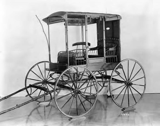 A wooden wagon that is pulled by hand.