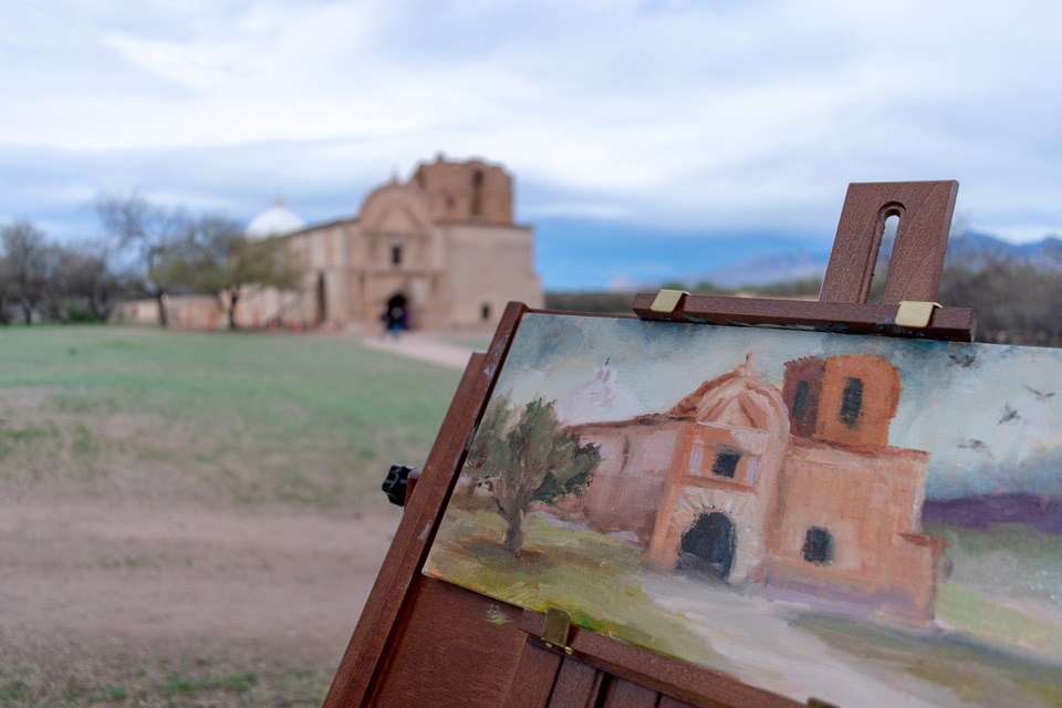 painting of church in foreground with actual church in background