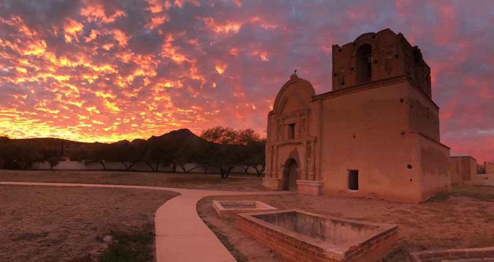 orange and pink sunset with church