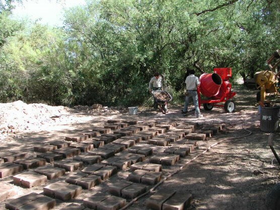 workers build adobe bricks