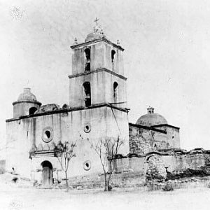 black and white historic photo of mission church with 4-story large bell tower