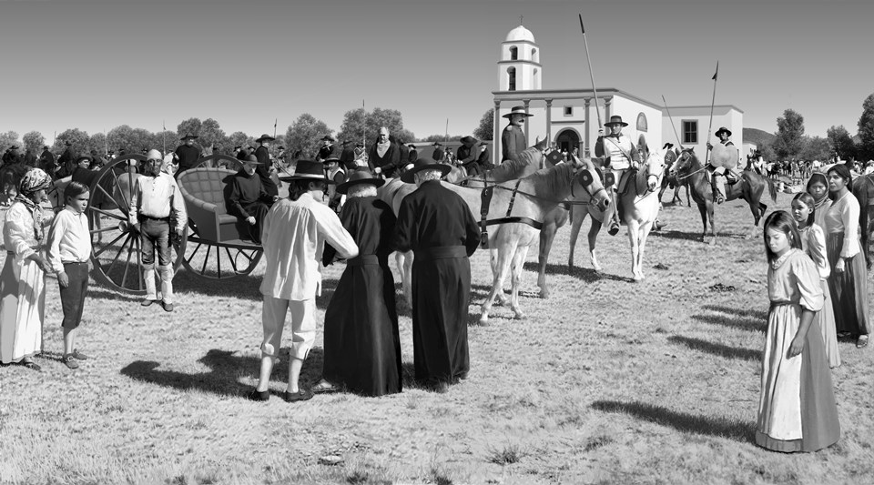 black and white photo of jesuit priests being led by spanish soldiers onto volante