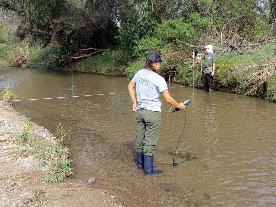 two women in river with monitoring equipment