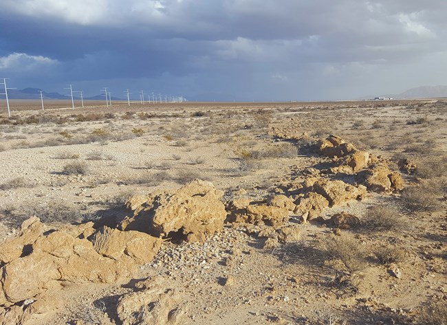 Rocks form the shape of a winding stream in a desert landscape