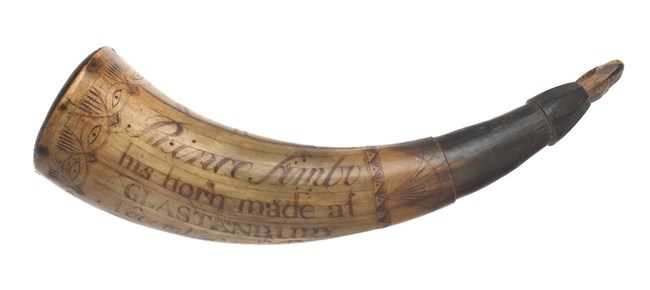 A carved cow horn that Private Prince Simbo used to carry gunpowder