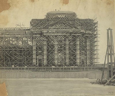 A large classical building under construction.