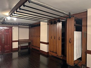 A room with large rack for drying linens.
