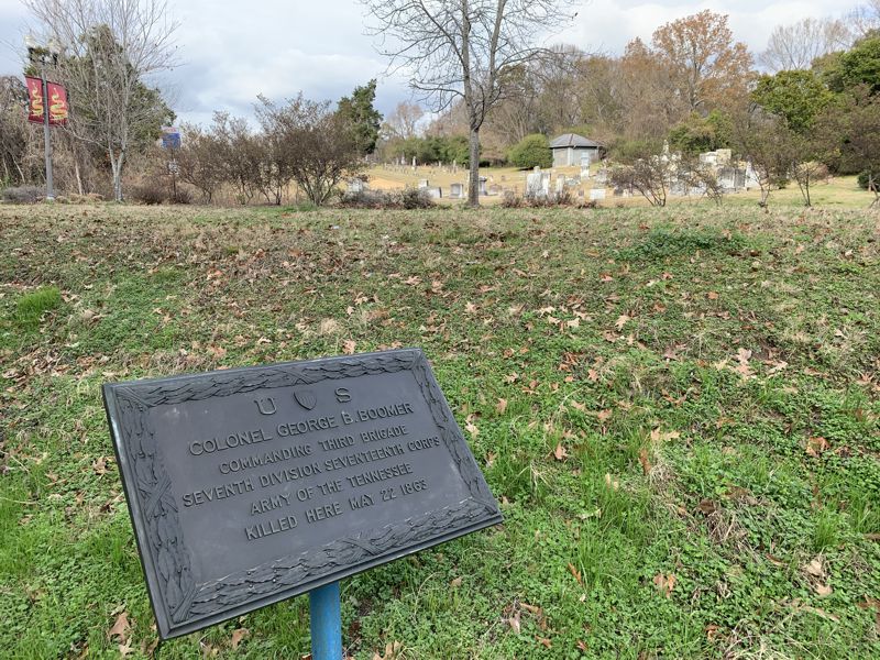 A bronze rectangular sign designating the location where Colonel George Boomer was killed on May 22, 1863.
