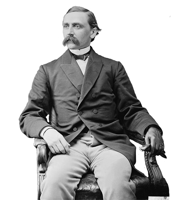 A black and white image of a man with mustache sitting in a chair.