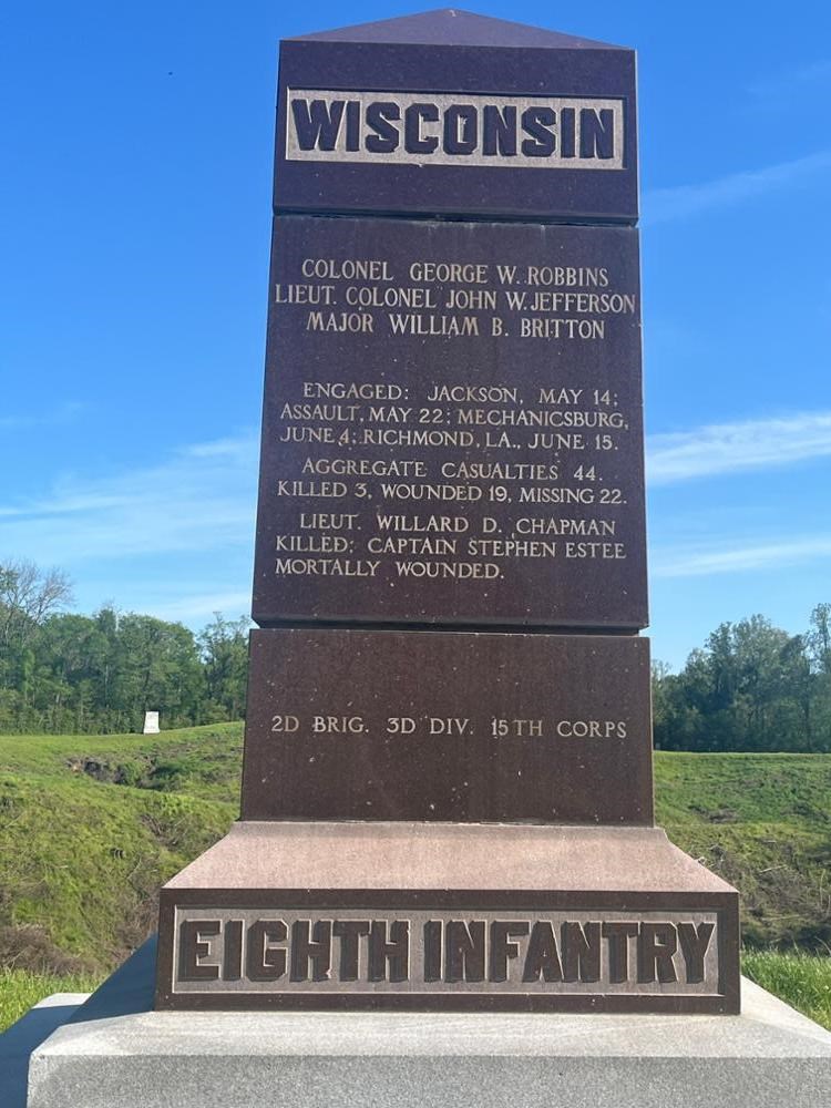 Tall, reddish brown granite monument