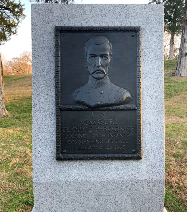 A bronze relief monument of George B. Boomer.