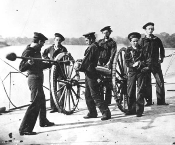 navy crew manning a howitzer on land