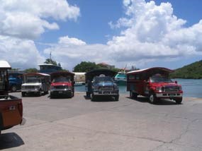 Safari Taxis line up at the old vehicle ferry ramp in Cruz Bay.