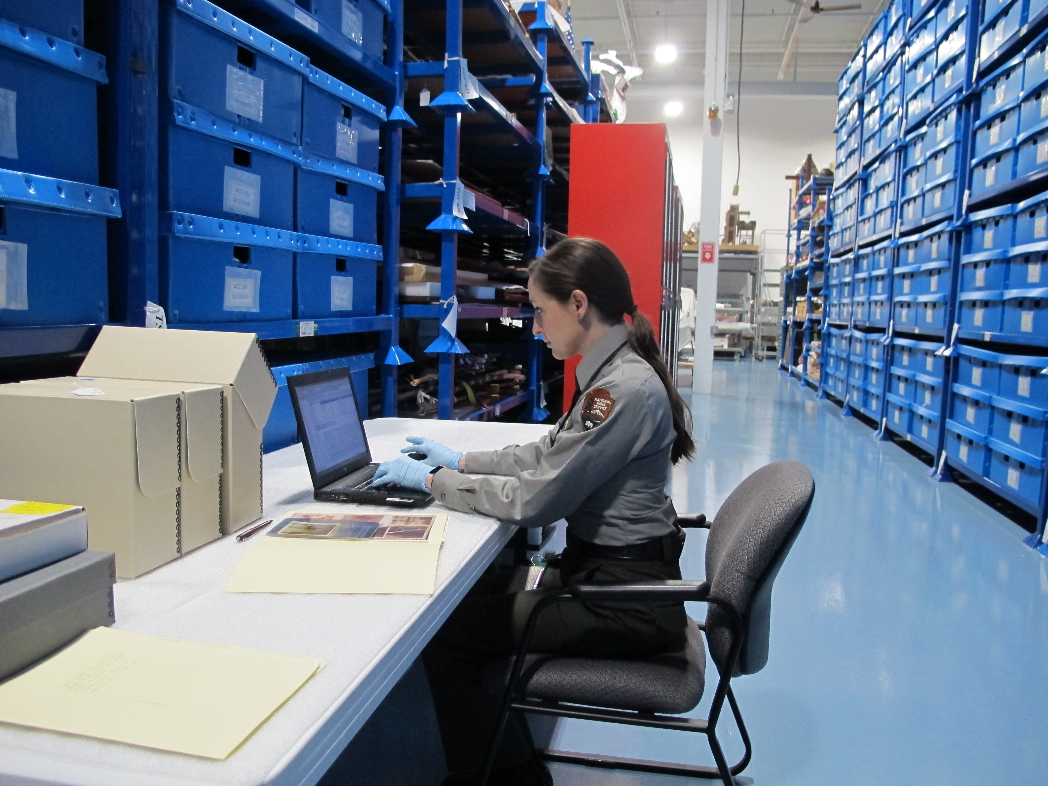 NPS Conservator entering items into storage