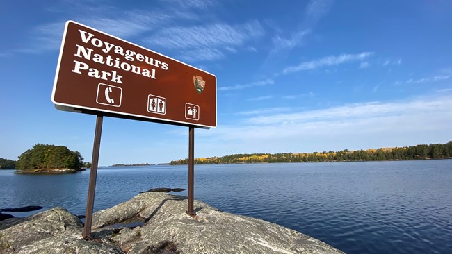 A Voyaguers National Park sign on a rock point on Lake Kabetogama