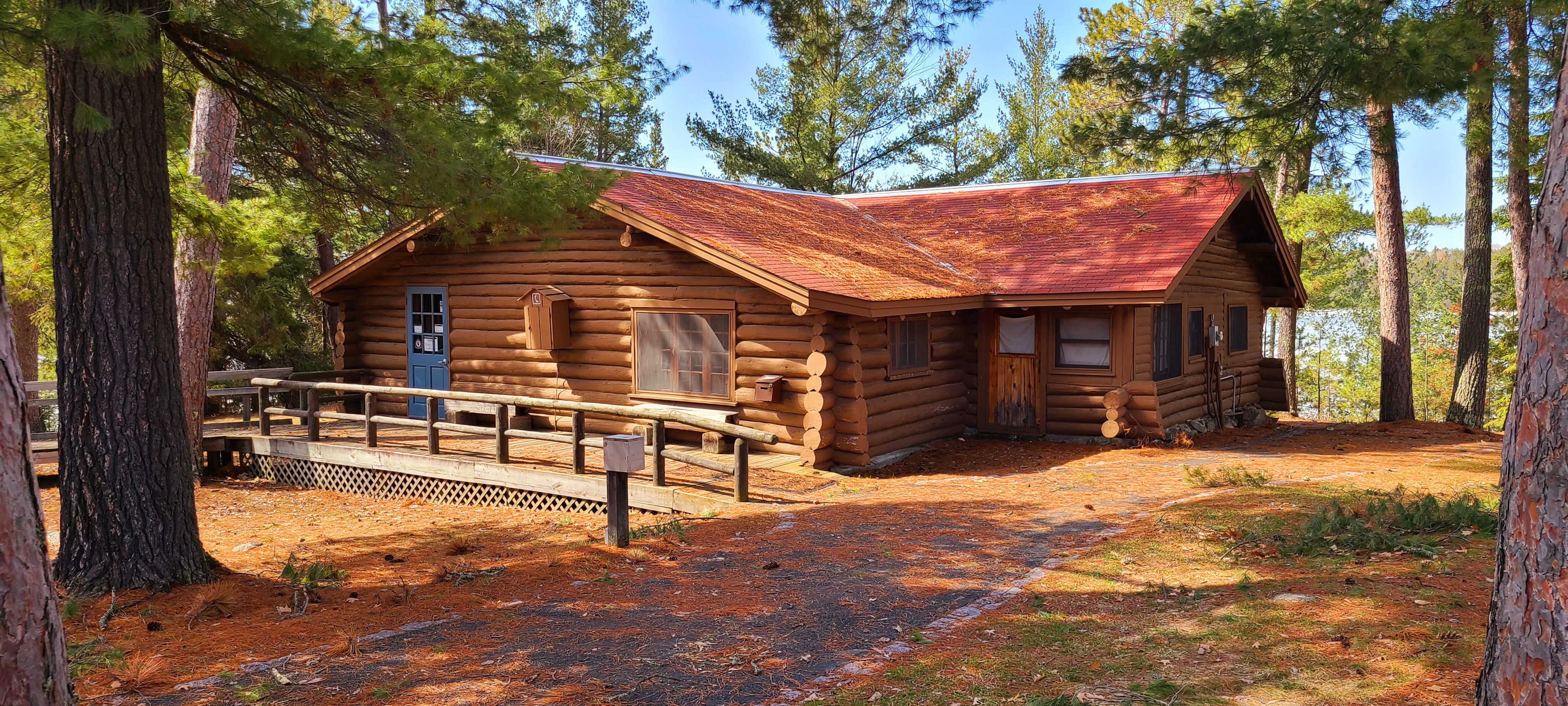 Ash River Visitor Center, formerly Meadwood Lodge, an old log constructed design, sits among towering pines above the shoreline of Kabetogama Lake