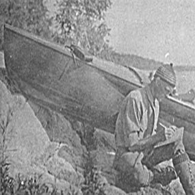 I.W. Stevens sitting by his boat.
