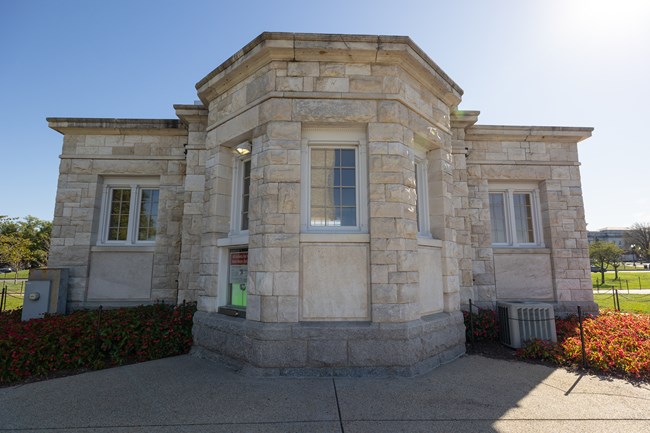 The back side of the Monument Lodge with a ticket booth window on the left.