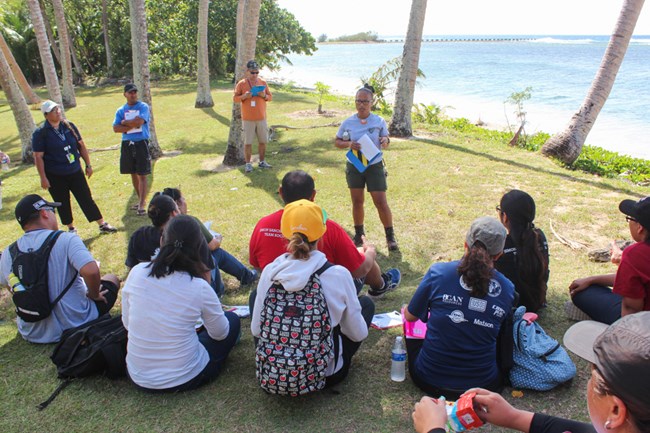 Teachers join a park ranger at Ga'an Point to learn about the unique resources of War in the Pacific NHP.