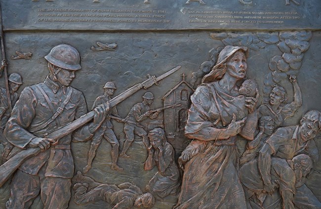 Carved bronze panel showing a soldier and a woman carrying a baby