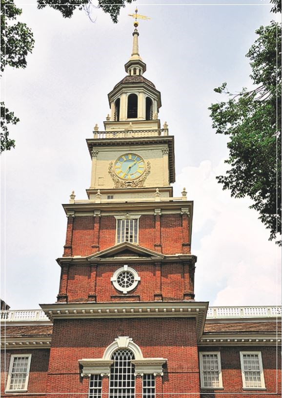 A multi-story red brick clock tower