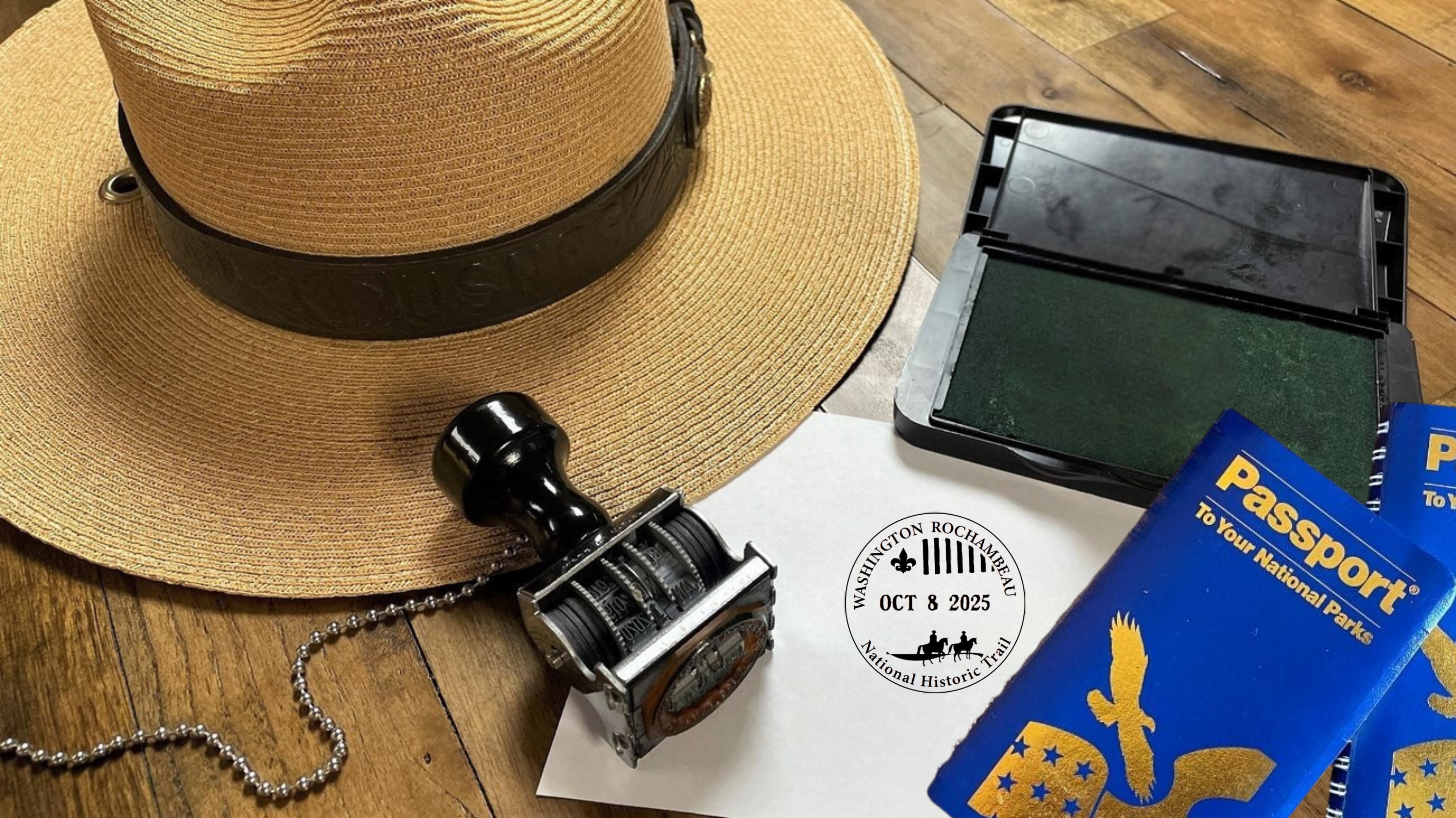 NPS park ranger hat with trail passport stamp and passport to your national parks book